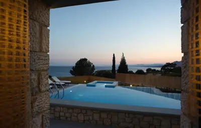 a villa with a swimming pool at dusk at Blue Dream Exclusive villas privees in Pefki Rhodes