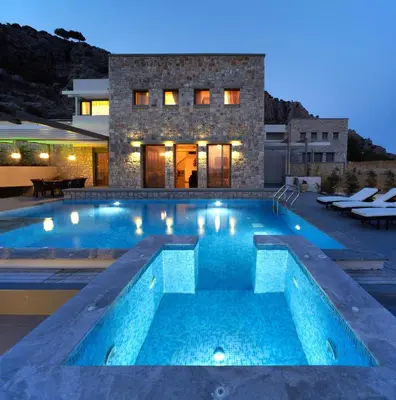 a swimming pool in front of a house at Blue Dream Exclusive villas privees in Pefki Rhodes