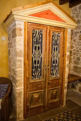 a large wooden door in a brick wall at George & Alexandra's Apartments in Rhodes Town
