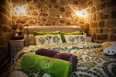 a bedroom with two beds with green pillows at George & Alexandra's Apartments in Rhodes Town