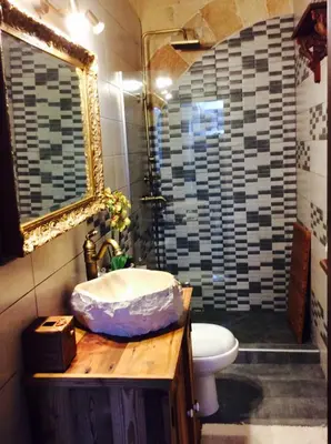 a bathroom with a sink and a toilet and a mirror at George & Alexandra's Apartments in Rhodes Town