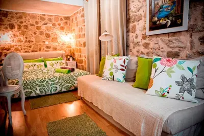 a small room with a couch and a bed at George & Alexandra's Apartments in Rhodes Town