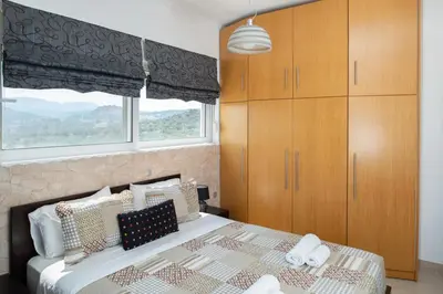 a bedroom with a bed and a large window at Villa Elia in Kolimbia