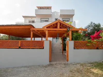 a building with a wooden canopy and a staircase at Villa Elia in Kolimbia