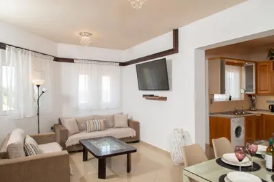 a living room with a couch and a table at Villa Elia in Kolimbia