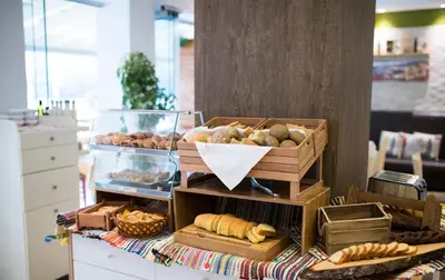 a table topped with lots of different types of bread at Island Boutique Hotel in Rhodes Town