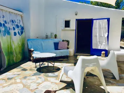 a living room with a blue couch and a table at Sandra Studio in Lachania