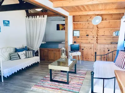 a living room with a couch and a tv at Sandra Studio in Lachania