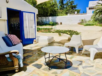 a patio with chairs and a table on a stone floor at Sandra Studio in Lachania