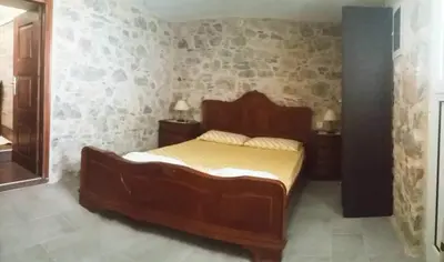 a bedroom with a large wooden bed in a room at Spiros Apartments in Livadia