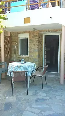 a table and two chairs on a patio at Spiros Apartments in Livadia