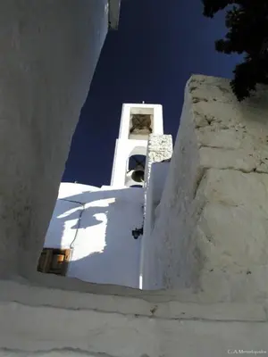 a view of a white building with a clock tower at Spiros Apartments in Livadia