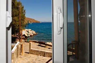 a view of the ocean from a door of a house at Spiros Apartments in Livadia