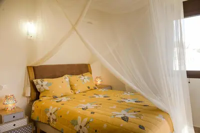 a bedroom with a bed with a canopy at The Corner House at Gennadi Court in Gennadi