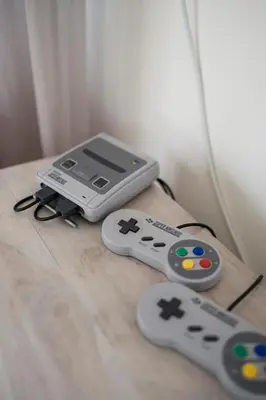 two video game controllers sitting on top of a table at The Corner House at Gennadi Court in Gennadi
