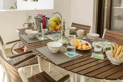 a wooden table with bowls of fruit on it at The Corner House at Gennadi Court in Gennadi