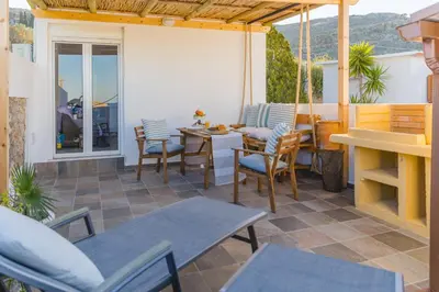 a patio with chairs and a table on a patio at Lindos SeaSide Junior Apartment in Líndos