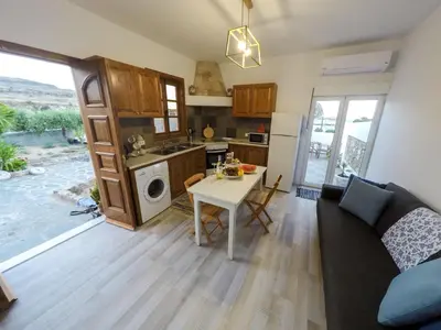 a living room with a couch and a table at Lindos SeaSide Junior Apartment in Líndos