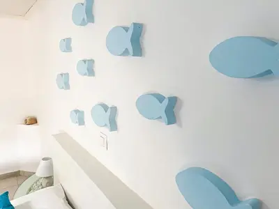 a wall with blue hearts on a white wall at Carpe Diem Studios in Ialyssos