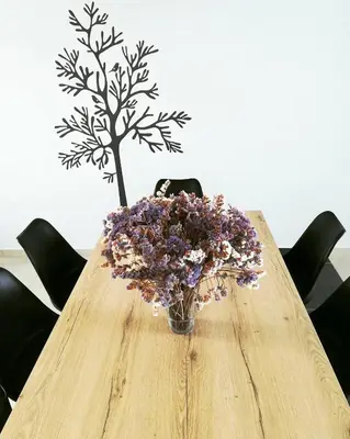 a vase of flowers sitting on a wooden table at Rhodes Sea Villas in Ixia