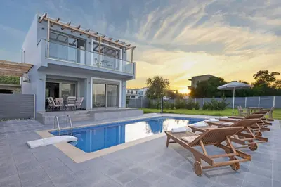 a villa with a swimming pool and a house at Rhodes Sea Villas in Ixia