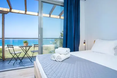 a bedroom with a bed and a large window at Rhodes Sea Villas in Ixia