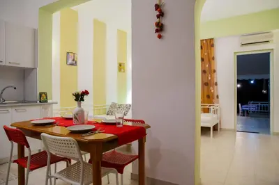 a kitchen and dining room with a table and chairs at St Peter & Paul at haraki in Haraki