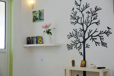 a white wall with a tree stenciled on it at St Peter & Paul at haraki in Haraki