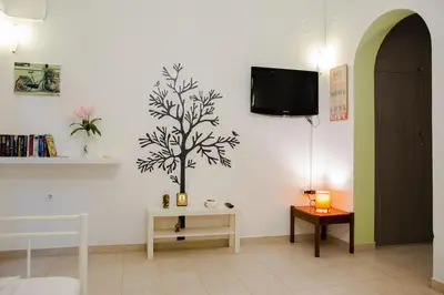 a living room with a tree stenciled on the wall at St Peter & Paul at haraki in Haraki