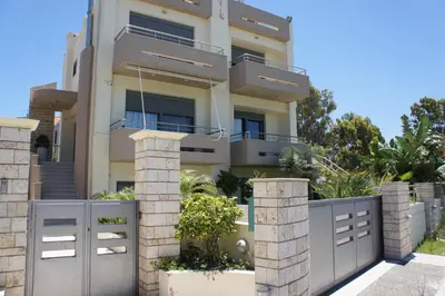 a house with a gate and a fence at Ixia Beach in Ialyssos