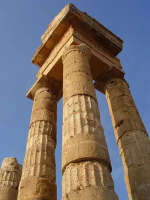 two stone columns in front of a blue sky at Ixia Beach in Ialyssos