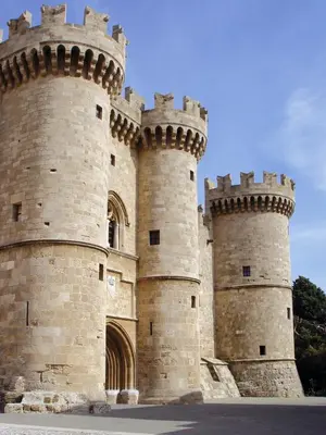 a large castle with two towers at Ixia Beach in Ialyssos