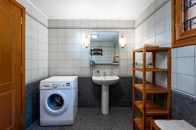 a bathroom with a washing machine and a sink at Over The Sea Apartments in Symi