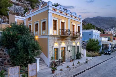a house on the side of a hill at Over The Sea Apartments in Symi