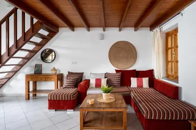a living room with red couches and a table at Over The Sea Apartments in Symi
