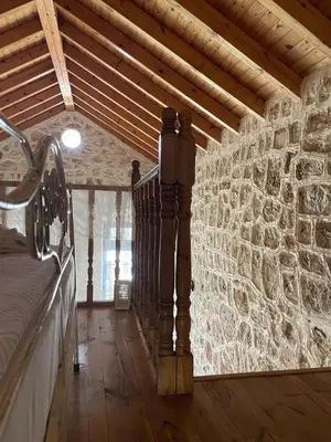 a room with a stone wall with a bed in it at Marina Castellana Studios in Halki