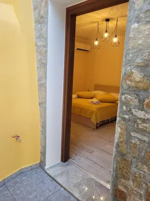 a view of a bedroom with a bed and a mirror at Kleanthi and Kostas Studios in Symi