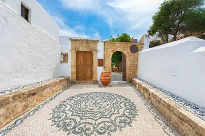 a house with a door and a tile floor at Villa Eftihia in Lindos in Líndos