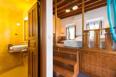 a bathroom with a sink and a bed in a room at Villa Eftihia in Lindos in Líndos