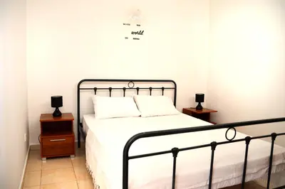 a bedroom with a bed and two night stands at Sky-Line Apartments in Afantou