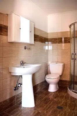 a bathroom with a sink and a toilet at Sky-Line Apartments in Afantou