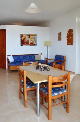 a dining room with a wooden table and chairs at Sky-Line Apartments in Afantou