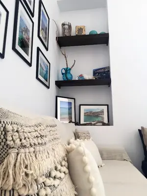 a bedroom with a bed with a blanket and pictures on the wall at Villa Miranda in Halki