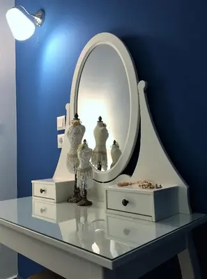 a dressing table with a mirror on a blue wall at Villa Miranda in Halki