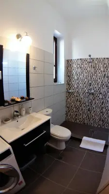a bathroom with a toilet and a sink and a shower at Villa Miranda in Halki