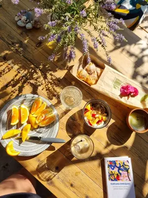 a wooden table topped with plates of food and fruit at Ktima Natura in Archangelos