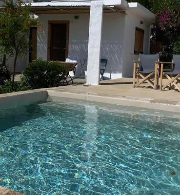 a swimming pool in front of a house at Ktima Natura in Archangelos