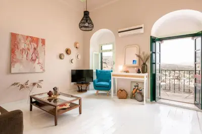 a living room with a couch and a table and a tv at Aerino in Symi