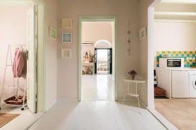 a room with a hallway with a door open to a kitchen at Aerino in Symi