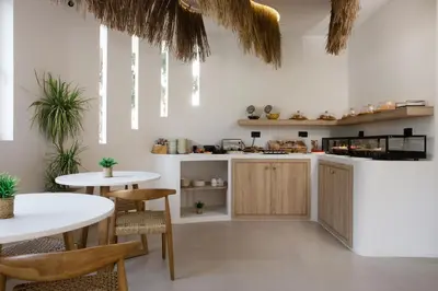 a kitchen with two tables and two tables at Stay Helios in Faliraki